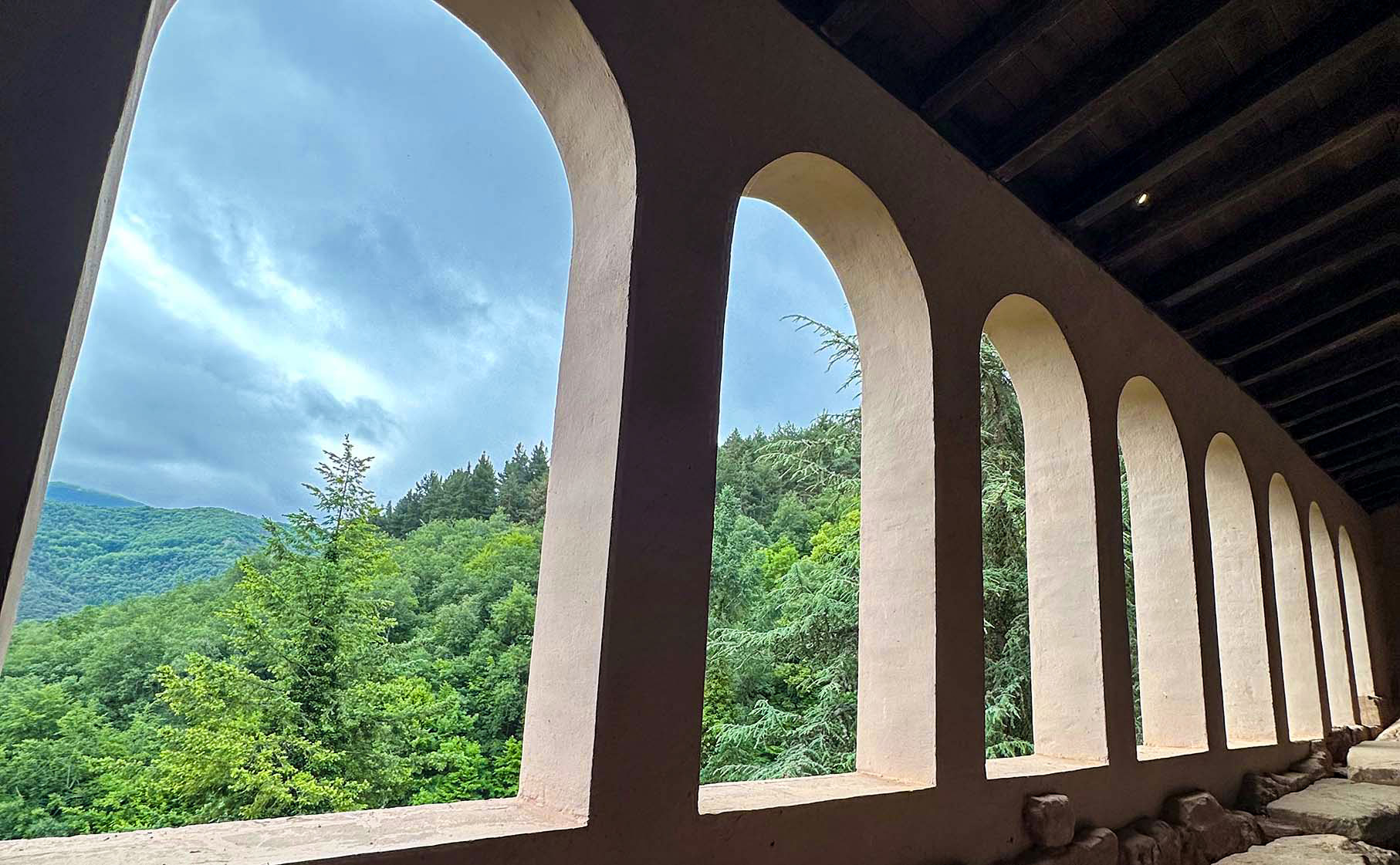 Arched windows of San Milán de la Cogolla Suso opening onto a forest